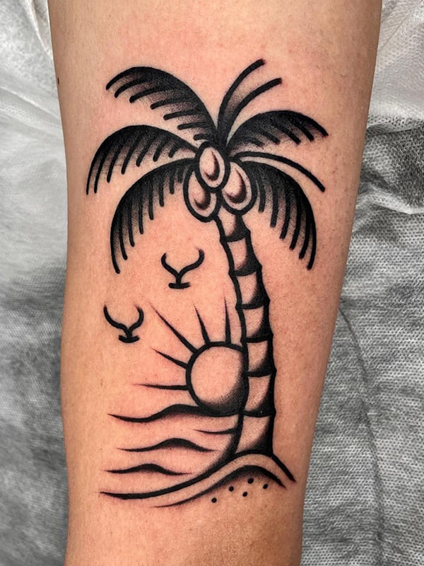 Minimalistic palm tree tattoo located on the inner arm